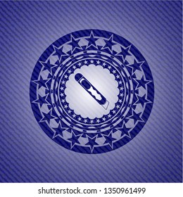 cutter icon inside badge with denim background