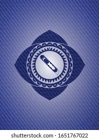 cutter icon inside badge with jean texture