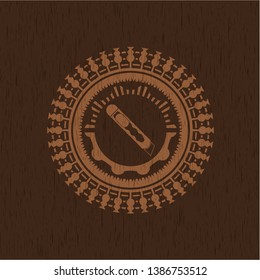 cutter icon inside badge with wood background