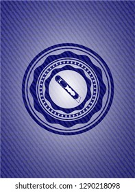 cutter icon inside denim background