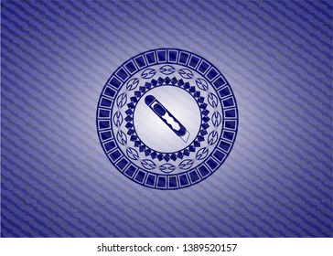 cutter icon inside emblem with denim texture