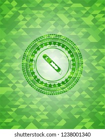 cutter icon inside green emblem with mosaic background