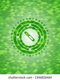 cutter icon inside green emblem with mosaic background
