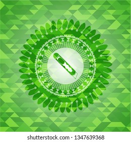 cutter icon inside green emblem with mosaic background