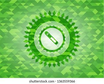 cutter icon inside green emblem with mosaic background