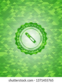 cutter icon inside green mosaic emblem
