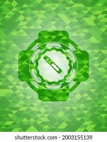 cutter icon inside green mosaic emblem. 
