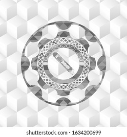 cutter icon inside grey badge with geometric cube white background
