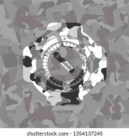 cutter icon inside grey camouflaged emblem