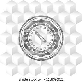 cutter icon inside grey emblem with cube white background