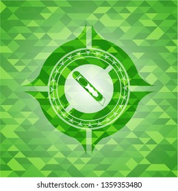 cutter icon inside realistic green emblem. Mosaic background