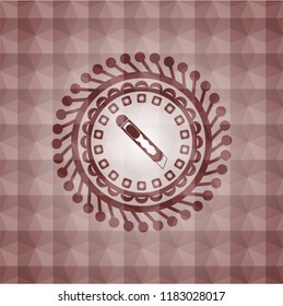cutter icon inside red seamless badge with geometric pattern background.