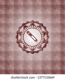 cutter icon inside red seamless emblem or badge with abstract geometric pattern background.
