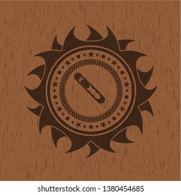 cutter icon inside wood badge or emblem