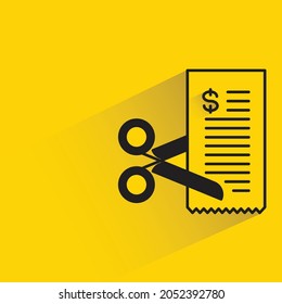 cutting bill with scissors on yellow background