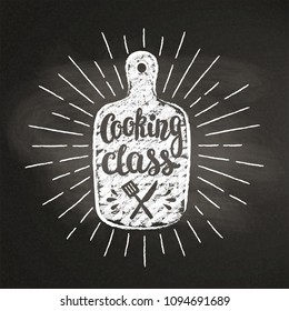 Cutting board chalk silhoutte with sun rays and lettering - Cooking class - on blackboard. Good for cooking logotypes, bades or posters.