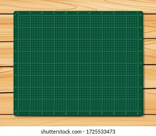 Cutting Mat On Wood Texture Background. Green Cutting Mat.