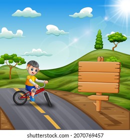 A cyclist rides a bike on a road among the hills