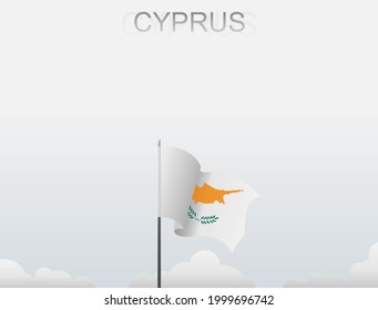 The Cyprus flag flutters on a pole standing tall under a white sky