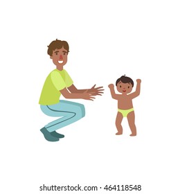 Dad Crouching To Catch Walking Toddler