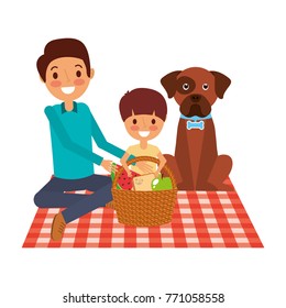dad and son their dog sitting on picnic blanket with basket dinner