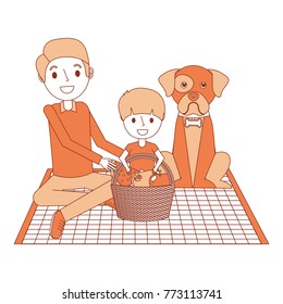 dad and son their dog sitting on picnic blanket with basket dinner