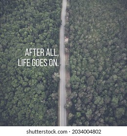 daily motivational quote design reads "After all, life goes on." straight road background in the middle of the forest