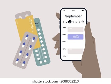 Daily pills intake, a hand holding a mobile phone with a digital calendar displayed on the screen