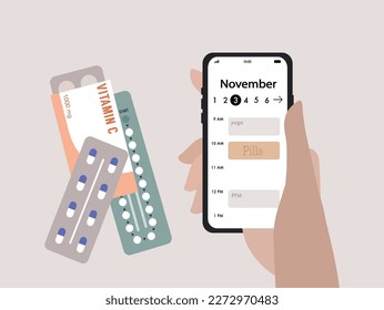 Daily pills intake, hand holding a mobile phone with a digital calendar displayed on the screen. Medical and healthcare concept.