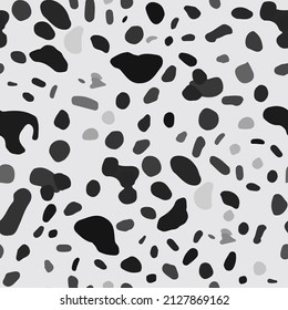 Dalmatian abstract pattern. Random spots and blots of various shapes. Seamless pattern with geometric black shapes on white. The texture of the skin of wild animals, giraffe, cheetah, cow. Vector 