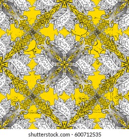 Damask pattern repeating background. Golden yellow floral ornament in baroque style. Antique golden repeatable wallpaper.Golden element on yellow background.