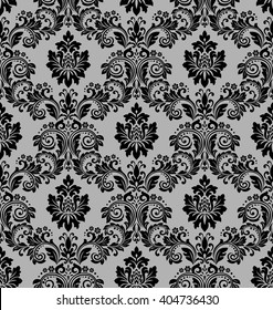 Damask seamless floral pattern. Royal wallpaper. Flowers on a black background. Luxurious vector ornament.