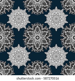 Damask seamless pattern repeating background. Golden floral ornament in baroque style. Antique white repeatable wallpaper. Golden element on blue background.