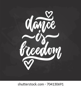 Dance is freedom - lettering dancing calligraphy quote drawn by ink in white color on the black chalkboard background. Fun hand drawn lettering inscription