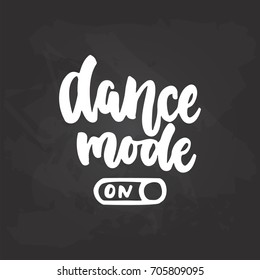 Dance mode On- lettering dancing calligraphy quote drawn by ink in white color on the black chalkboard background. Fun hand drawn lettering inscription