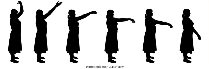 Dance teacher in a skirt, blouse. Hands in motion, legs without movement, standing still. Smooth, elegant, graceful hand movements. A group of women stands straight and moves their arms. Side view.