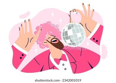 Dancing man with pink wig on head is holding disco ball and enjoying discotheque or music party. Funny dancing guy in bright suit works as tomada and entertains guests of festival or carnival