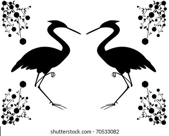 Dancing silhouettes of two birds on the background of the branches of wild cherry