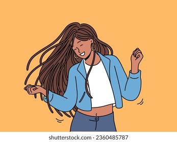 Dancing teenage girl enjoys rhythmic movements to music and swings long dreadlocks. Dancing ethnic woman in casual clothes, relaxing at disco or nightclub and dreams of becoming professional dancer