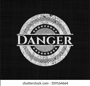 Danger chalkboard emblem written on a blackboard