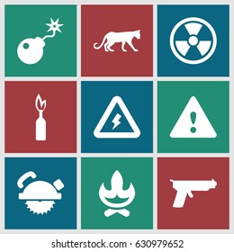 Dangerous icons set. set of 9 dangerous filled icons such as panther, saw blade, bomb, warning, voltage warning, dynamite, gun, radiation