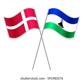 Danish and Basotho crossed flags. Denmark combined with Lesotho isolated on white. Language learning, international business or travel concept.