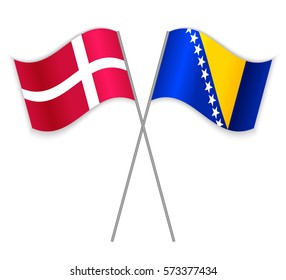 Danish and Bosnian crossed flags. Denmark combined with Bosnia and Herzegovina isolated on white. Language learning, international business or travel concept.