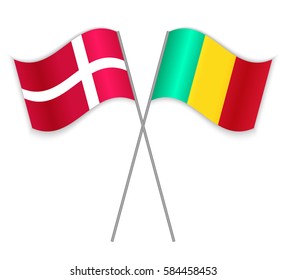 Danish and Guinean crossed flags. Denmark combined with Guinea isolated on white. Language learning, international business or travel concept.