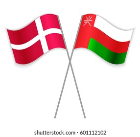 Danish and Omani crossed flags. Denmark combined with Oman isolated on white. Language learning, international business or travel concept.