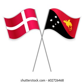 Danish and Papuan crossed flags. Denmark combined with Papua New Guinea isolated on white. Language learning, international business or travel concept.