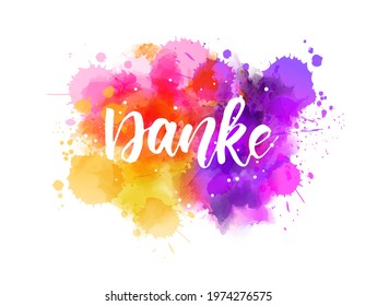 Danke - Thank you in German. Handwritten modern calligraphy lettering text on abstract watercolor paint splash background.