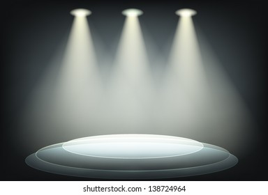 Dark background with brightly floodlit stage