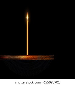 dark background and burning candle on the wooden stand with black veil