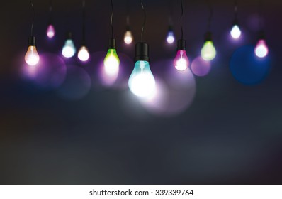 Dark background with  colorful light bulbs